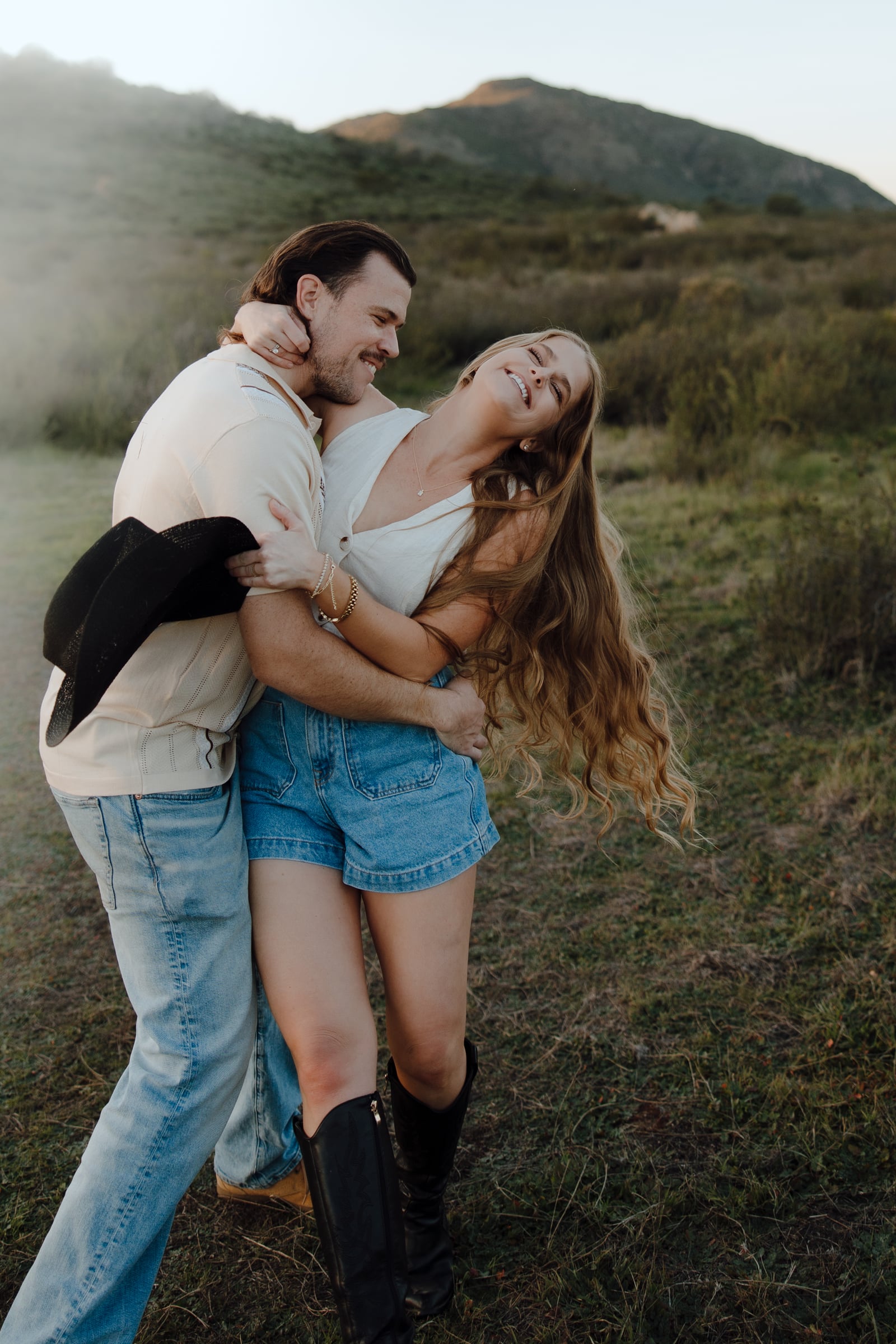 Erick and Sammie Heyl laughing together in a field